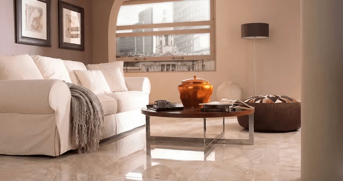 Modern living room with professionally installed marble flooring, a beige sofa, coffee table in Nashua, NH